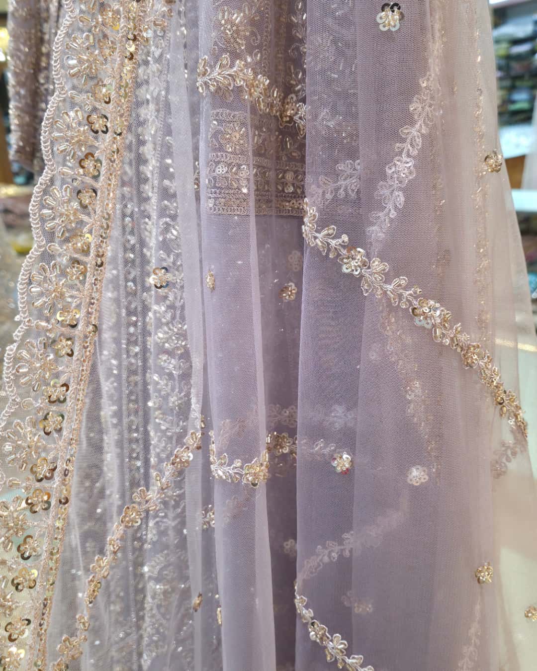 Full-length sheer net sleeve with delicate embroidery on dusty lavender front slit Anarkali dress.