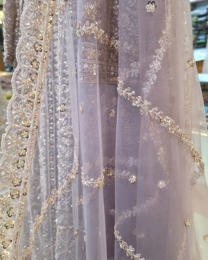 Full-length sheer net sleeve with delicate embroidery on dusty lavender front slit Anarkali dress.