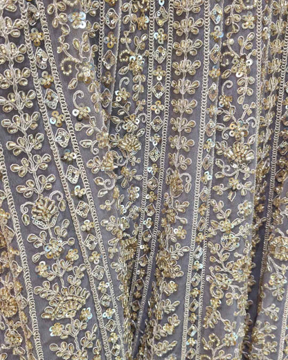 Dusty lavender net dupatta with scalloped embroidered border paired with front cut Anarkali gown.