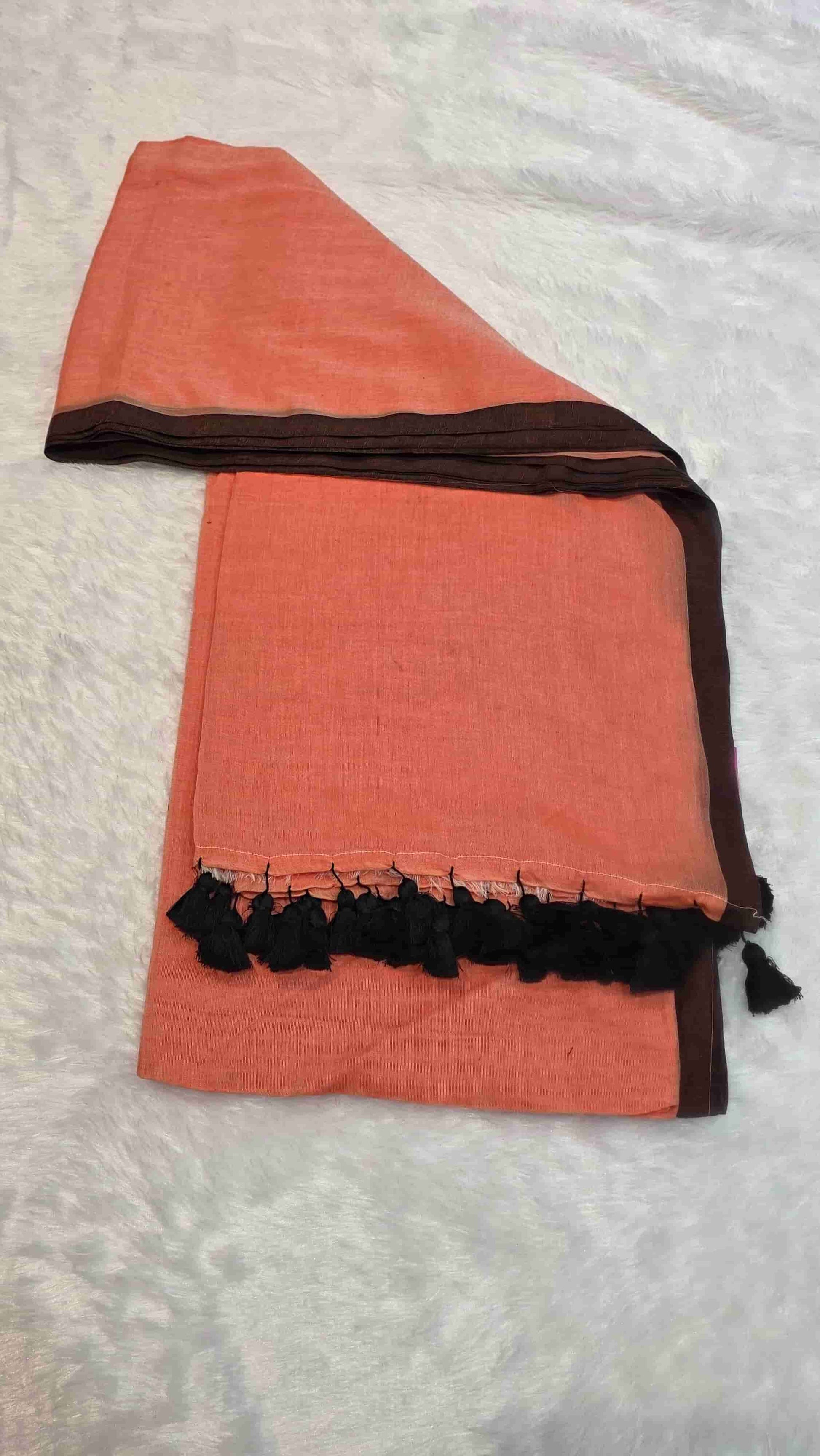Elegant dusty peach mulmul cotton saree with black border and tassel pallu