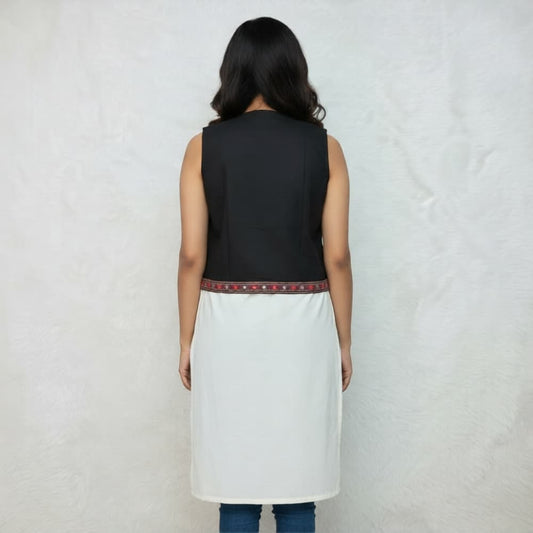 Ethnic black sleeveless koti with geometric patterns and pom pom tassels