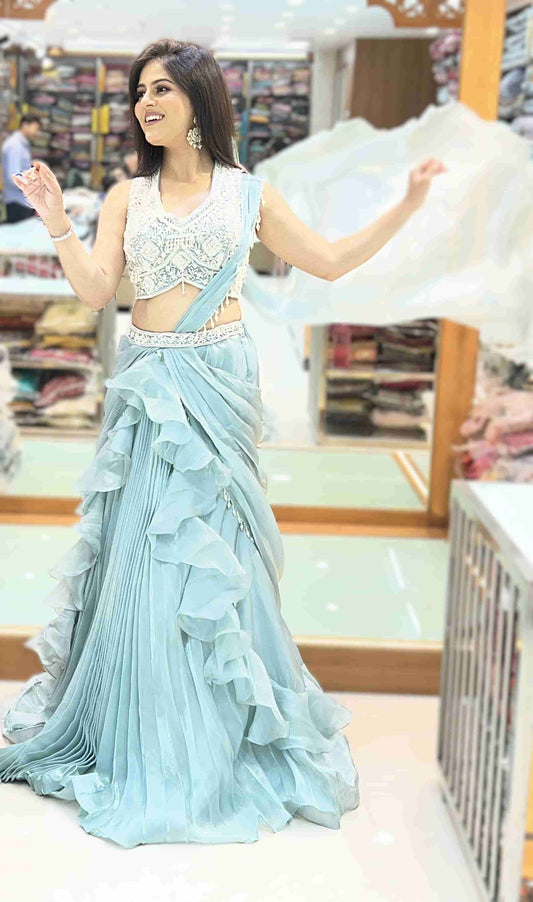 Ice blue Indo-Western ruffle lehenga set with embellished sleeveless blouse and draped dupatta full front view.