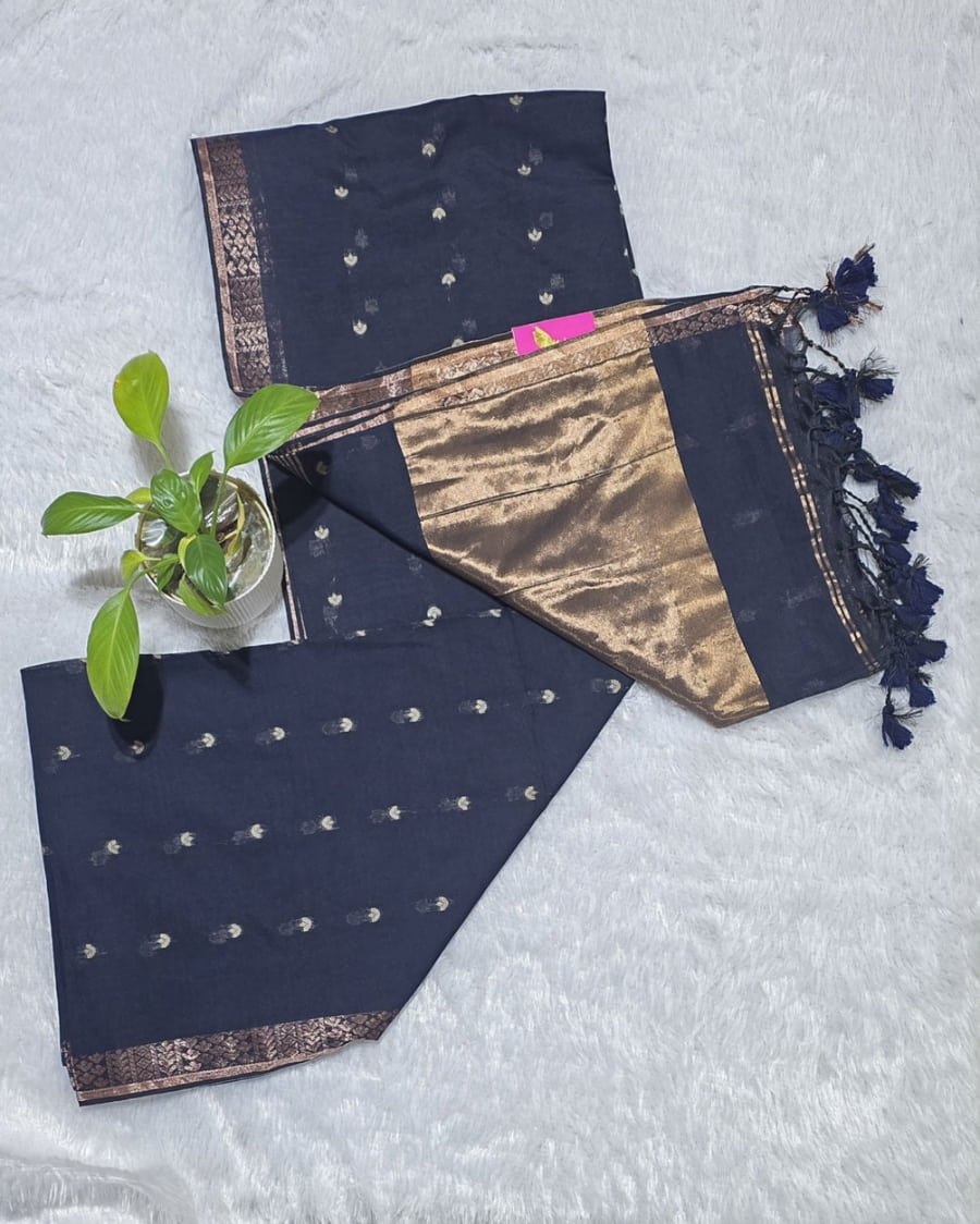 Indigo blue cotton saree featuring butti weaving throughout, copper zari pallu detailing and golden border with tassels perfect for casual gatherings