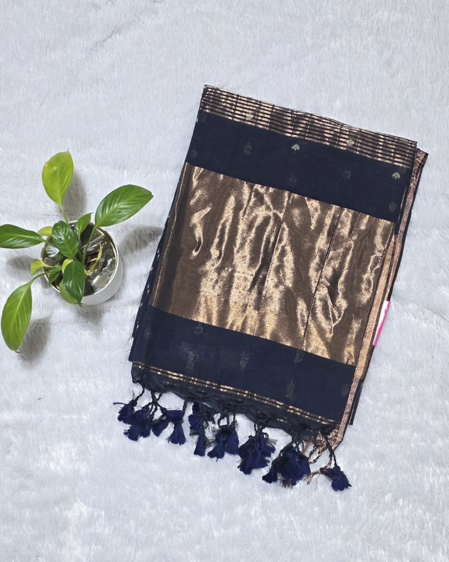 Indigo blue cotton saree featuring butti weaving throughout, copper zari pallu detailing and golden border with tassels perfect for casual gatherings