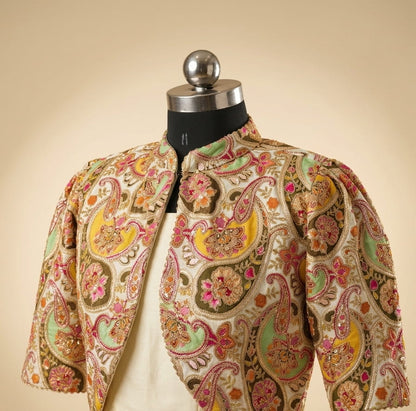 Ivory draped gown with embroidered colorful jacket