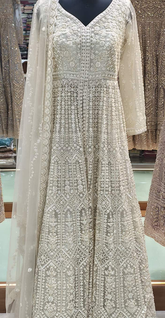 Ivory front cut Anarkali gown with heavy pearl and sequin embroidery, floor-length flared silhouette with net dupatta.