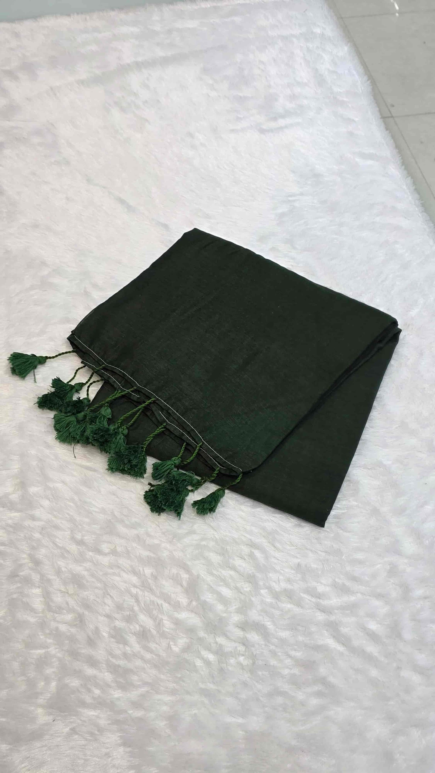 Soft mulmul cotton saree in bottle green with handcrafted tassels