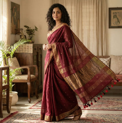 Maroon cotton saree with traditional copper butti weaving, copper zari pallu, and elegant golden zari border.