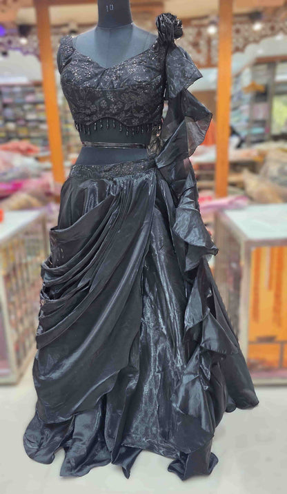 Detailed view of metallic shimmer black lehenga skirt with layered draping and ruching