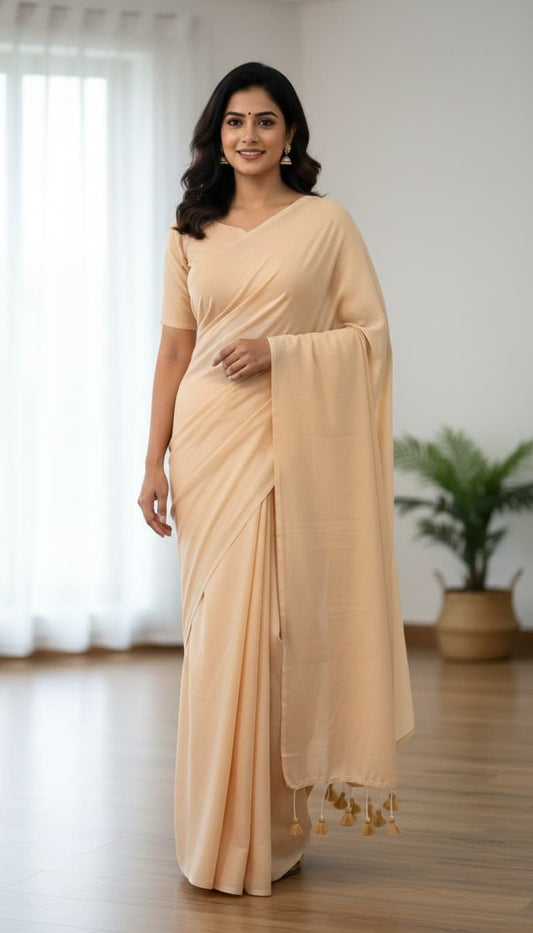 Cream mulmul cotton saree with hand-tied tassels on edge