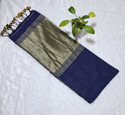 Traditional navy blue cotton saree adorned with butties, copper zari work on the pallu, and classic golden edge with tassels.