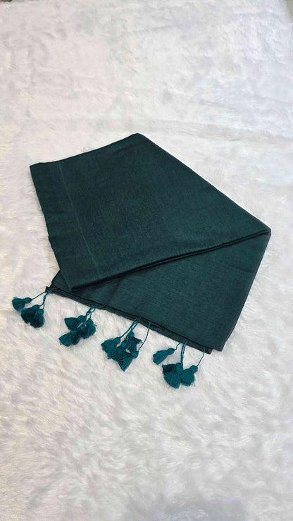 Lightweight mulmul cotton saree in dark teal green with hand-tied tassels