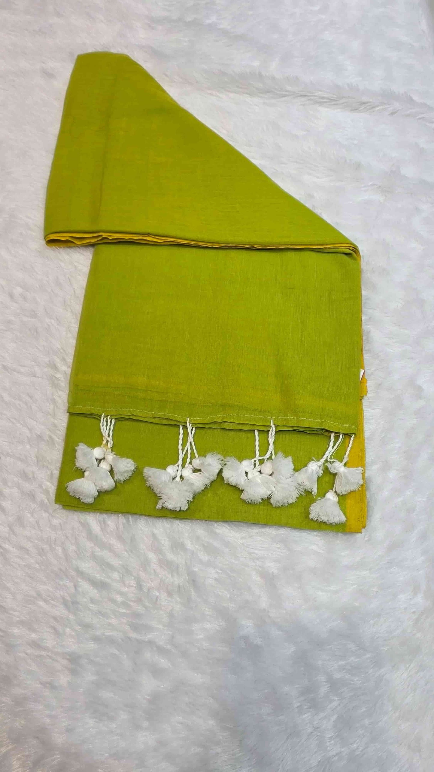 Lightweight olive green mulmul cotton saree with mustard yellow border and tassels