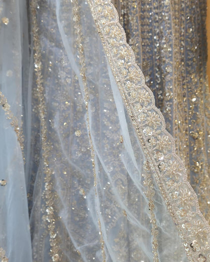 Full-length sheer net sleeve with delicate embroidery on powder blue front slit Anarkali dress.