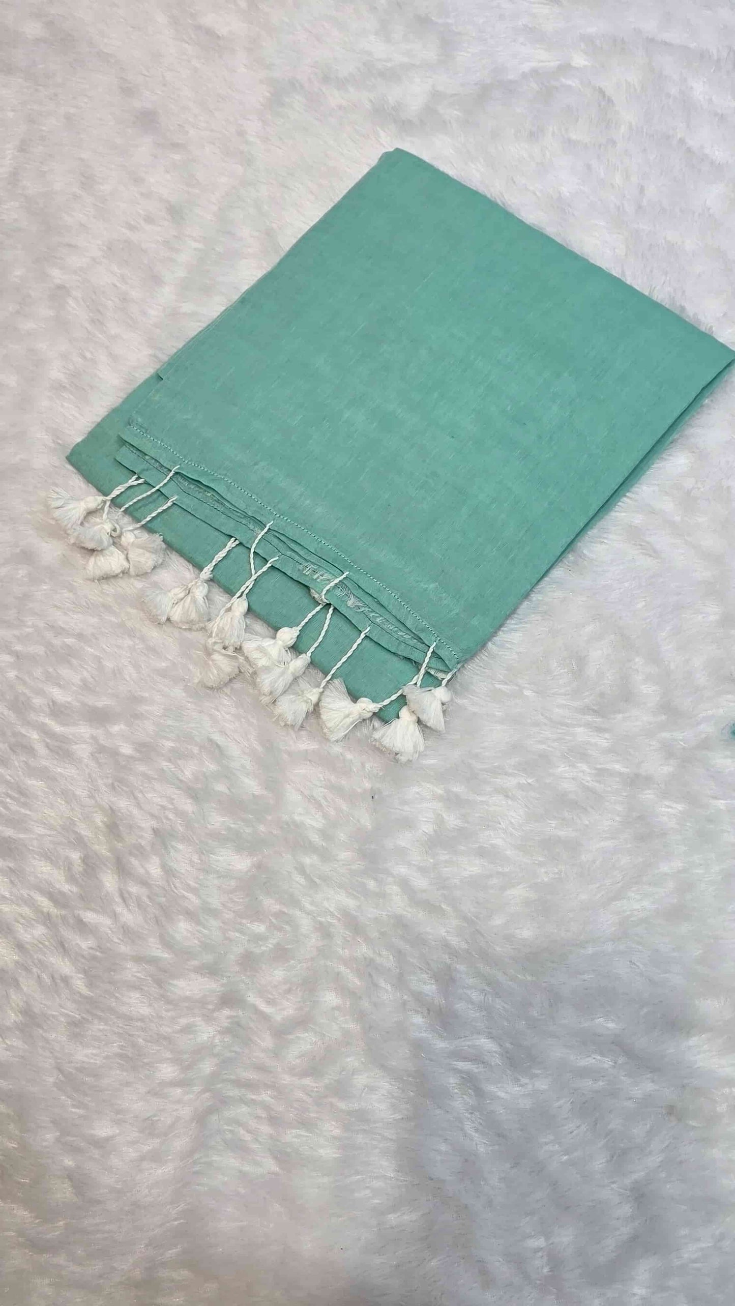 Elegant sea green mulmul cotton saree with hand-tied tassels