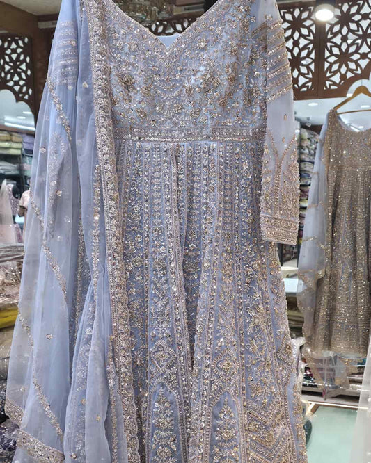 Powder blue front cut Anarkali gown with heavy zari and sequin embroidery, flared floor-length silhouette with net dupatta.