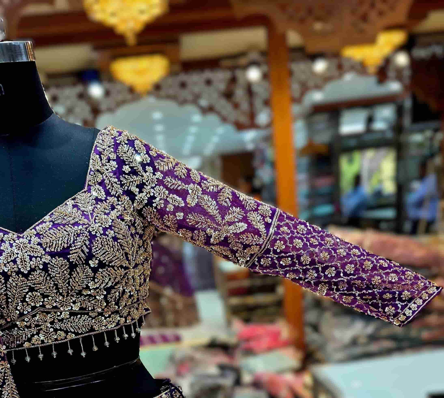 Flared royal purple lehenga with jaal pattern embroidery and heavy floral border detailing.