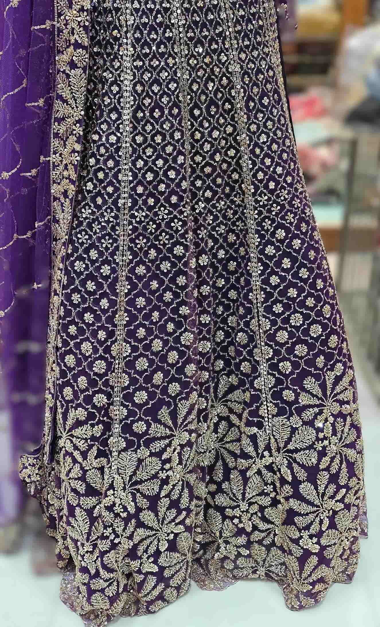 Flared royal purple lehenga with jaal pattern embroidery and heavy floral border detailing.