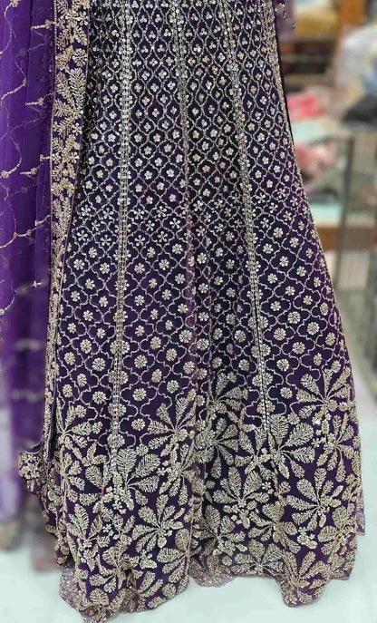 Flared royal purple lehenga with jaal pattern embroidery and heavy floral border detailing.