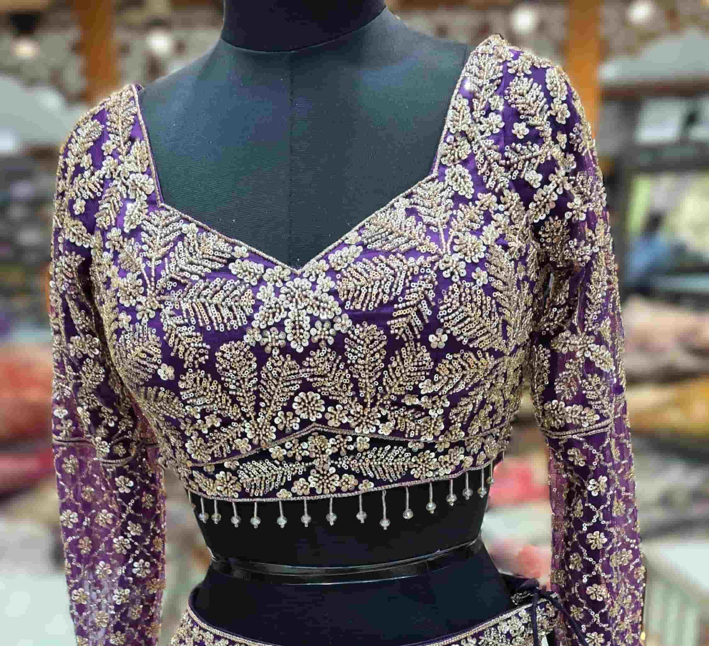 Designer royal purple lehenga set with embroidered sleeves and net dupatta for wedding wear.