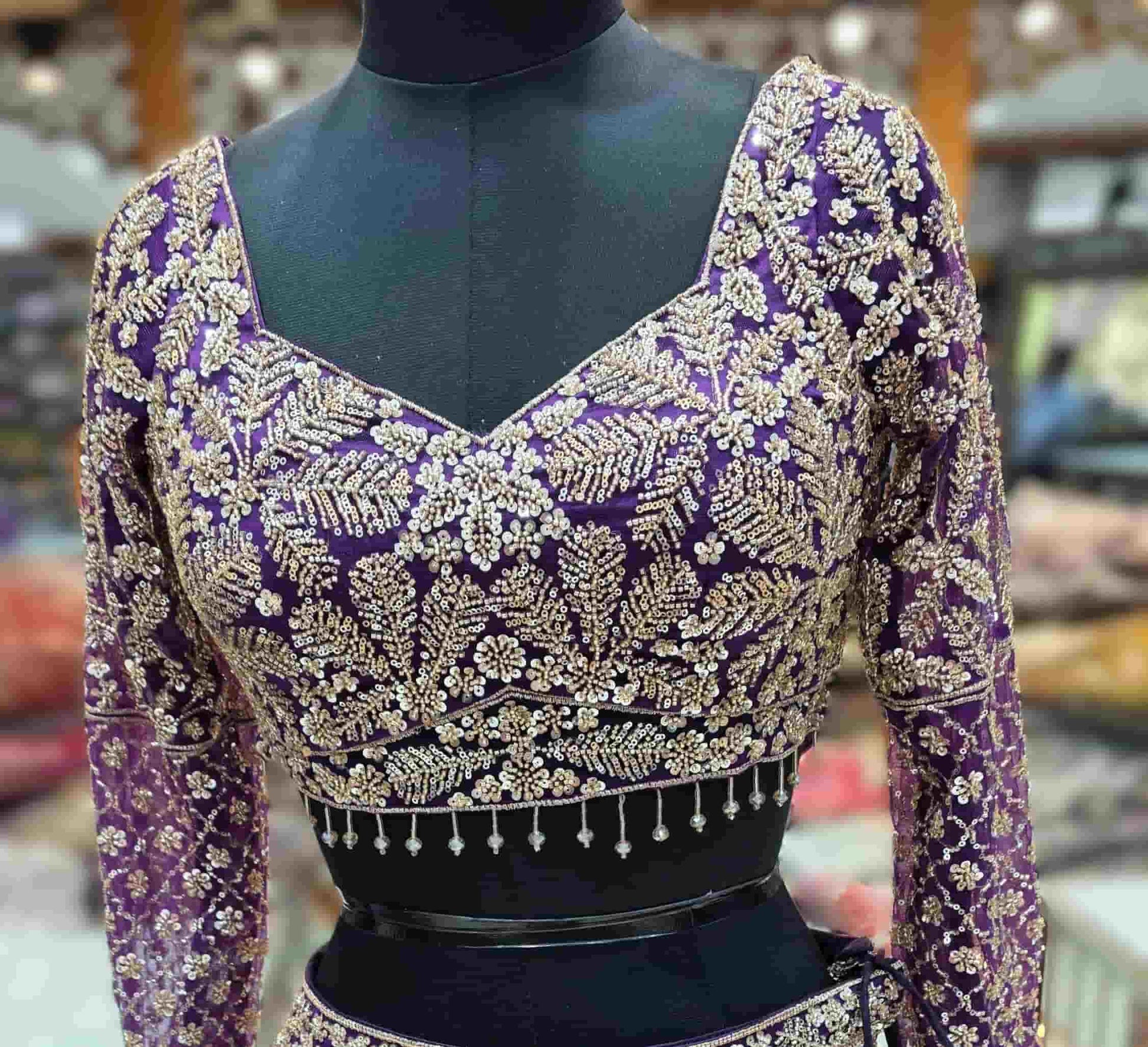 Designer royal purple lehenga set with embroidered sleeves and net dupatta for wedding wear.