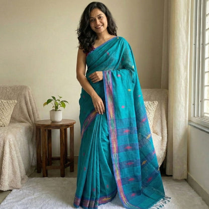 Sky blue cotton saree featuring small triangle butties, Ikat woven border, contrast pallu styling and tassel detailing. Perfect for office wear and daily wear.
