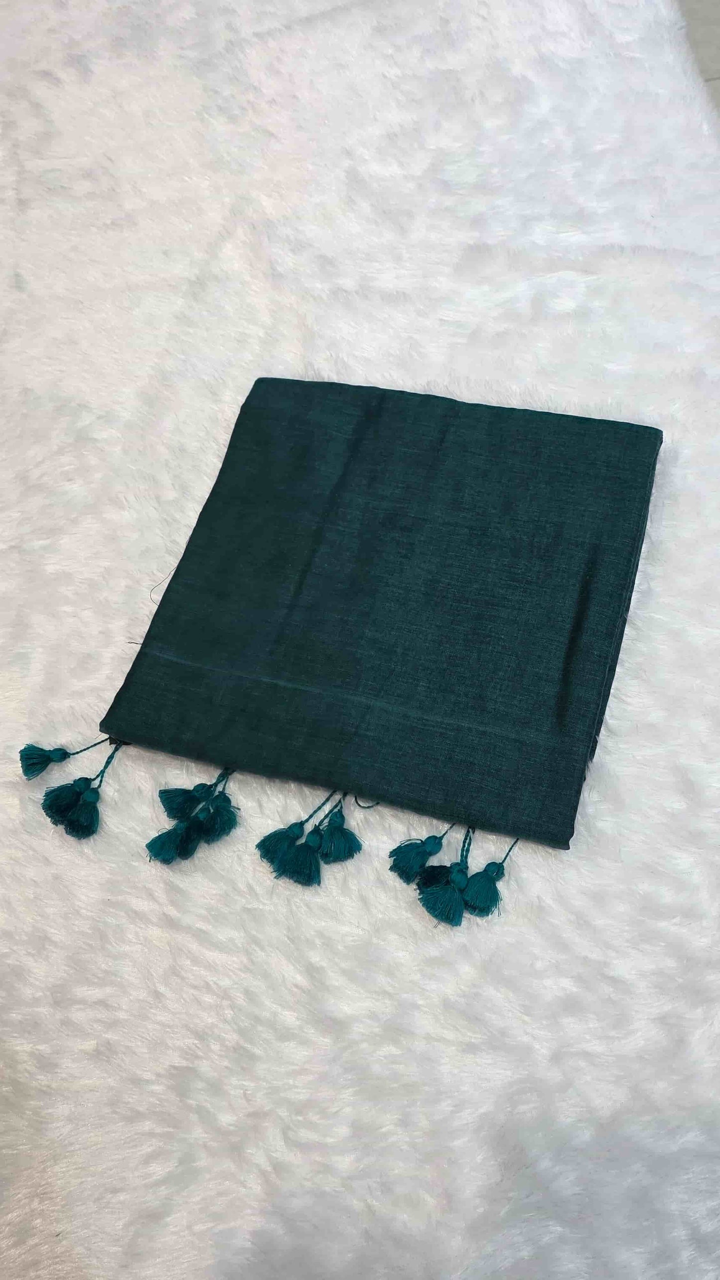 Soft mulmul cotton saree in dark teal green with tassel pallu