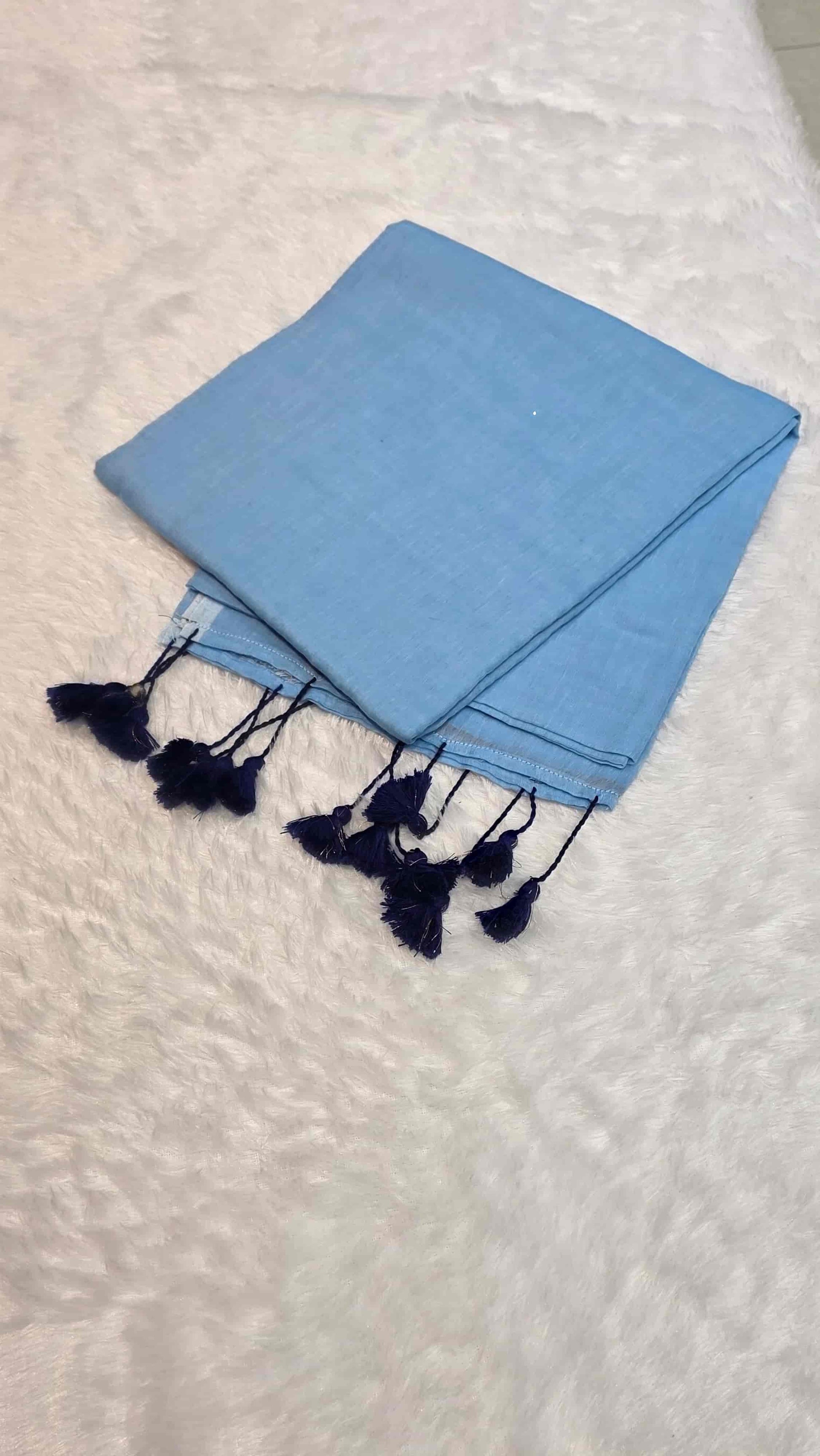 Elegant light blue mulmul cotton saree with hand-tied tassels