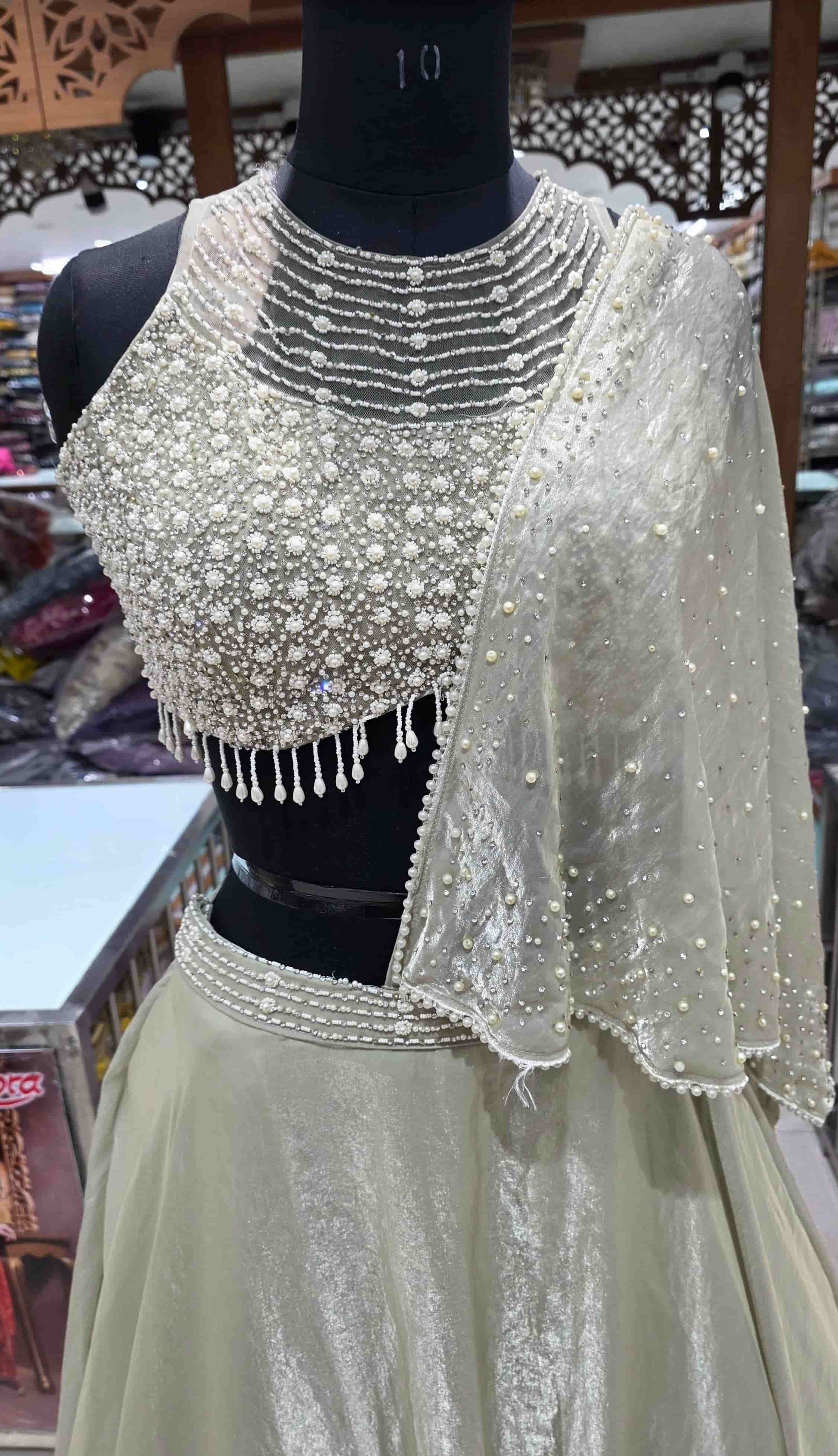 Close view of pearl embroidered blouse with layered neckline detailing in Indo-Western lehenga set