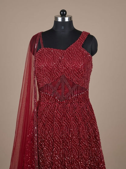 Wine red sequin embellished gown with corset bodice and net dupatta